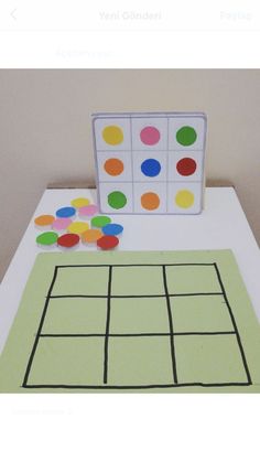 a table topped with paper cut outs and colored circles