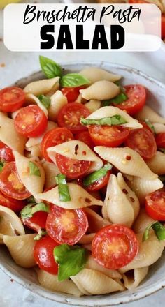 pasta salad with tomatoes and basil in a bowl