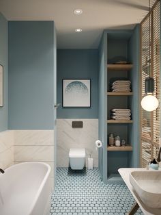 a bathroom with blue walls and flooring has a white bathtub next to the toilet