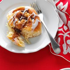 a white plate topped with a pastry covered in icing