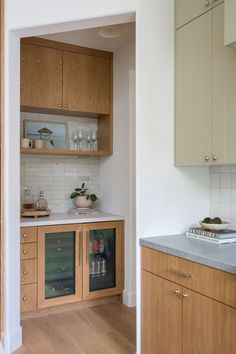 a kitchen with wooden cabinets and white walls