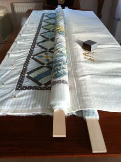 the table is covered with white linens and has a black piece of cloth on it