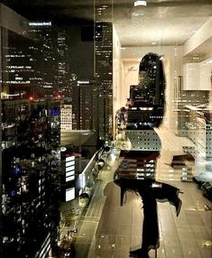 the city lights are reflected in the glass windows on the building's roof top