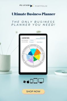 the ultimate business planner is on display in front of a computer screen and vase with flowers