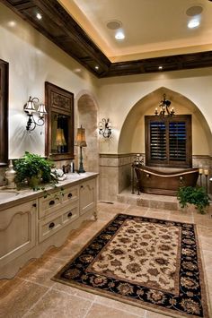 a large bathroom with two sinks and a bathtub in the middle of the room