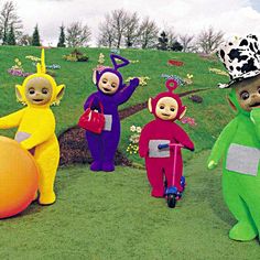 five inflatable characters are standing on the grass