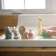 a baby is playing with toys in the bathtub