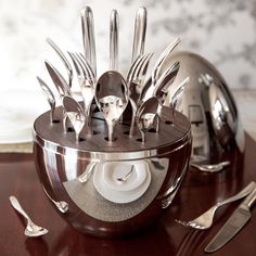 there are forks, knives and spoons in the holder