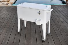 an ice chest sitting on top of a wooden deck