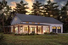 this is an artist's rendering of the modern farmhouse style home in the woods