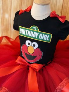 a black birthday shirt with an orange tutu and red ribbon around the bottom that says happy birthday girl