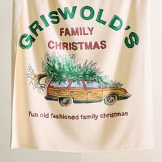 a christmas banner hanging on the wall with a car carrying a tree and saying, criswold's family christmas fun old fashioned family christmas