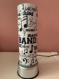 a white and black lamp with musical notes on it