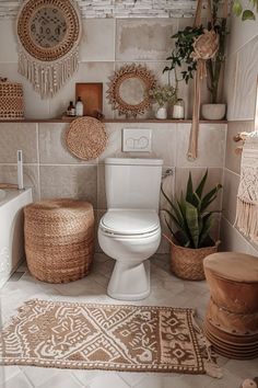 a white toilet sitting inside of a bathroom next to a rug and potted plants