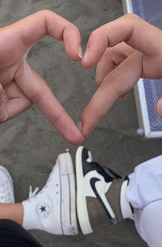 two people making a heart with their hands