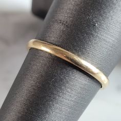 a gold ring sitting on top of a piece of cloth