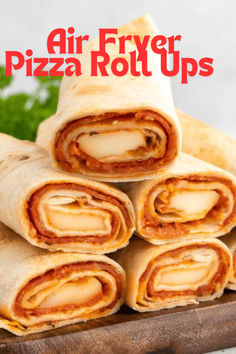 several pieces of pizza roll up sitting on top of a cutting board with the words air fryer pizza roll ups