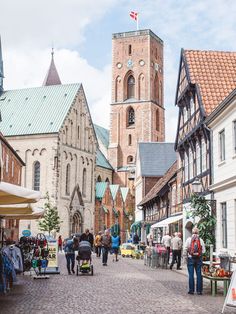 people are walking through an old european town