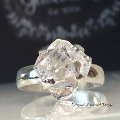 an old cut diamond ring sitting on top of a table