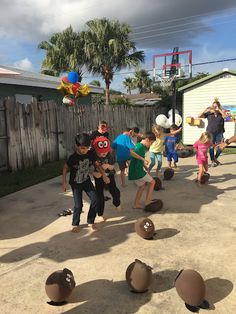 several children playing with balls in the backyard