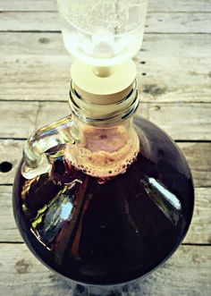 a bottle of elderberry mead sitting on top of a wooden table