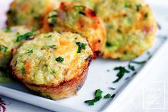 three small muffins on a white plate with parsley