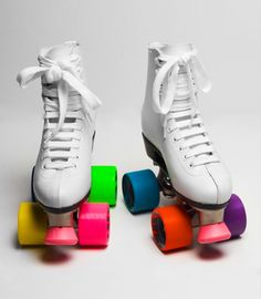 two white roller skates with colorful wheels