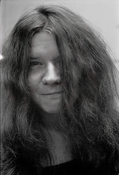 a black and white photo of a woman with long hair