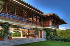 a large house sitting on top of a lush green field