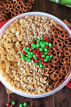 a bowl filled with cereal, pretzels and candy