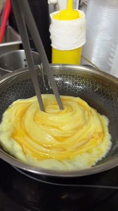 a frying pan filled with yellow sauce on top of a stove