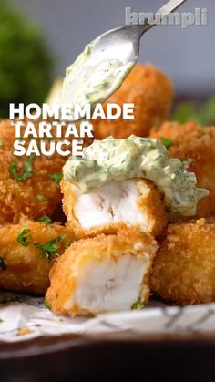 homemade tartar sauce being drizzled over tater tots