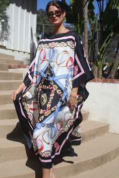 Designer print kaftan for dressy or casual wear.  Take on that cruise or just enjoy lounging elegantly or entertaining at home. One size.  Fits many sizes small to X-large.  The width is 52 inches, edge to edge, 104 around the body.  The side seams are 6 inches from the edge.  The length is 51 inches.  Machine wash on short, delicate cycle or hand wash. Chic Silk Kaftan For Beach Cover-up, Chic Long Kaftan For Beach Cover-up, Chic Long Kaftan For Beach Season, Black Silk Maxi Dress For Vacation, Elegant Long Kaftan For Beach Season, Chic Oversized Kaftan For Beach Cover-up, Casual Silk Kaftan For The Beach, Chic Maxi Length Kaftan For Beach Cover-up, Elegant Printed Beach Kaftan