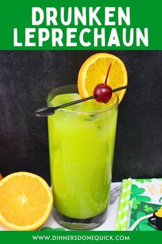 a green drink with oranges and cherries in it