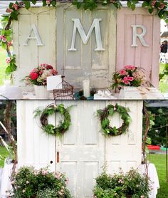 an old door is decorated with wreaths and flowers