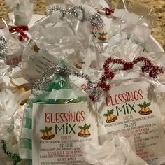 a basket filled with lots of bags of christmas candy and wrapped in plastic wrappers