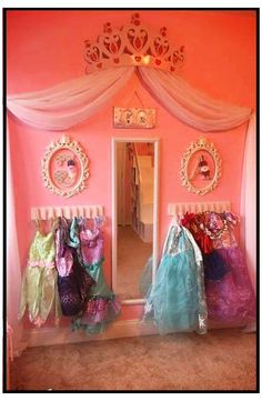 a room with pink walls and lots of bags on the floor