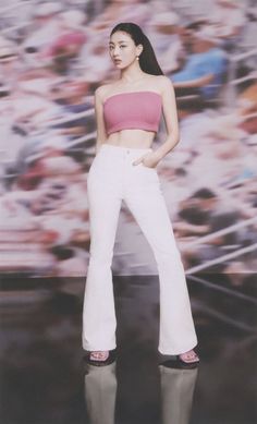 a woman in white pants and pink top