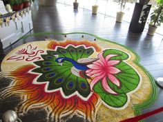 a colorful carpet with flowers and peacocks painted on it in front of a doorway