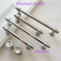 four chrome door handles and knobs on the side of a white window sill