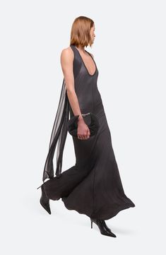 The NYC-based design house draws inspiration from the beauty of traditional dance costumes in this sweeping halter dress finished with cascading ties. Ties at back Halter neck Sleeveless, with cutaway shoulders 90% viscose, 10% elastane Dry clean Imported Designer Clothing Black Floor-length Halter Evening Dress, Fitted Silk Halter Dress Floor-length, Pre-draped Halter Neck Party Maxi Dress, Fitted Silk Floor-length Halter Dress, Silk Halter Dress With Back Opening For Party, Silk Halter Dress With Back Opening For Gala, Halter Neck Tie Back Evening Dress, Pre-draped Halter Neck Evening Dress For Gala, Evening Halter Maxi Dress With Tie Back