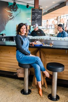 a woman sitting at a counter in a restaurant