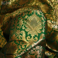 Indian Green Gold Brocade Fabric by the Yard Banarasi Lehenga Wedding Dresses Saree Fabric Sewing Crafting Home Decor Table Runner Cushion. This is a beautiful  benarse blended silk brocade motifs design fabric in Green and Gold. ➤Product: Brocade Fabric ➤Fabric Type: Blended Silk (Viscose and Silk)  Super Fine Quality Brocade Weaving from Banaras ➤Color: Green and Gold ➤Width: 44 inches. ➤Condition: New  ➤ Code: bg348 ➤Listing for 1 Yard of fabric. ➤Care: Dry Clean Only Which is known as "Kimkhab". During the Mughal period (1556-1707), when kimkhwāb was extremely popular with the rich, the great centres of brocade weaving were Benares (Vārānasi). You can use this fabric to make Dresses, Tops, Blouses, Jackets, Crafting, Clutches or Evening Bags, Embellish your clothes, Pillows, Drapery, H Luxury Banarasi Silk Embroidered Fabric For Eid, Luxury Banarasi Silk Embroidered Fabric In Traditional Style, Luxury Green Embroidered Wedding Fabric, Luxury Brocade Embroidered Dupatta Fabric, Luxury Banarasi Silk Fabric With Traditional Embroidery, Green Brocade Lehenga With Zari Weaving, Ceremonial Green Art Silk Lehenga, Green Brocade Dupatta For Traditional Ceremonies, Wedding Banarasi Silk Embroidered Fabric With Pallu