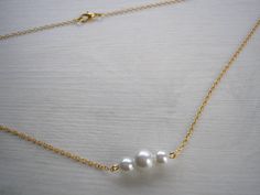 Triple Swarovski Pearl choker chain necklace, wear it alone for a minimalist look, or layer it with other necklaces for a more bohemian or statement look Handmade to order using 6 & 8mm genuine Swarovski crystal pearls on fine silver, gold or rose gold plated cable chain The necklace will be made to your chosen length (please see the size guide in the photo gallery) and fastens with a little lobster clasp Pretty organza gift bag and gift card included with the necklace presented on matching card Delicate White Choker With Delicate Chain, White Delicate Chain Choker, White Adjustable Chain Necklace For Wedding, Adjustable White Chain Necklace For Wedding, Minimalist Gold Bridal Necklace, Minimalist Gold Bridal Necklace With Delicate Chain, Minimalist Pearl Chain Choker, Wedding Choker Chain Necklace With Adjustable Chain, Adjustable Choker Chain Necklace For Wedding