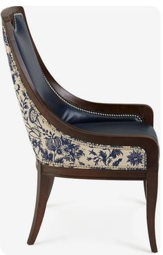 a blue and white upholstered chair with an intricately decorated armrests