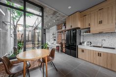 an open kitchen and dining area with large windows