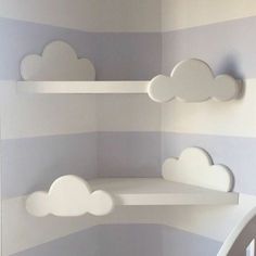 there is a shelf with clouds on it in the corner of this room, painted blue and white