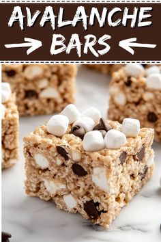 an image of dessert bars with marshmallows and chocolate chips on top that are ready to be eaten