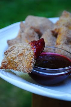 a white plate topped with fried food and dipping sauce