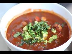 a white bowl filled with soup and vegetables